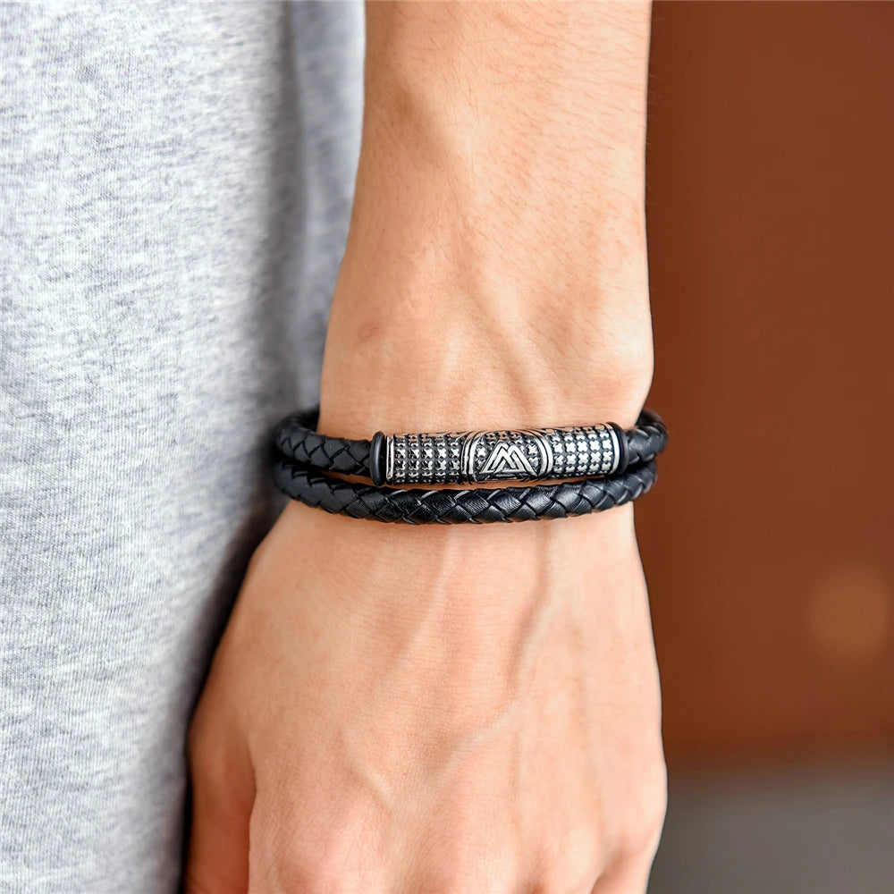 Stainless steel clasp bracelet with Valknut on black leather rope.