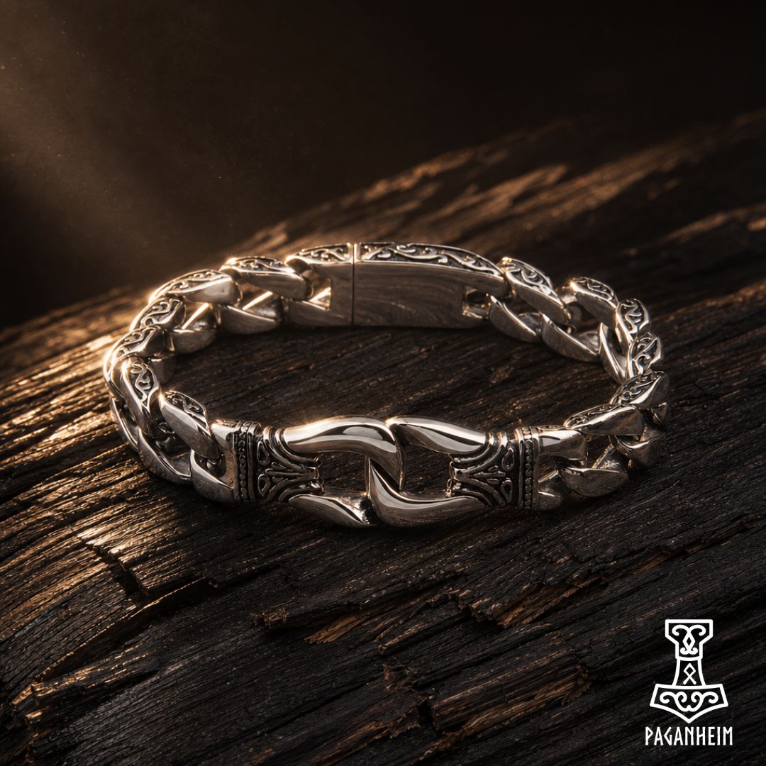 Silver bracelet featuring engraved clasp and interlocking Cuban links.