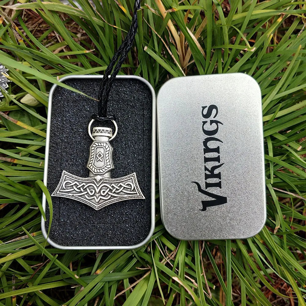 Mjölnir amulet with Othala rune engraving in silver color.