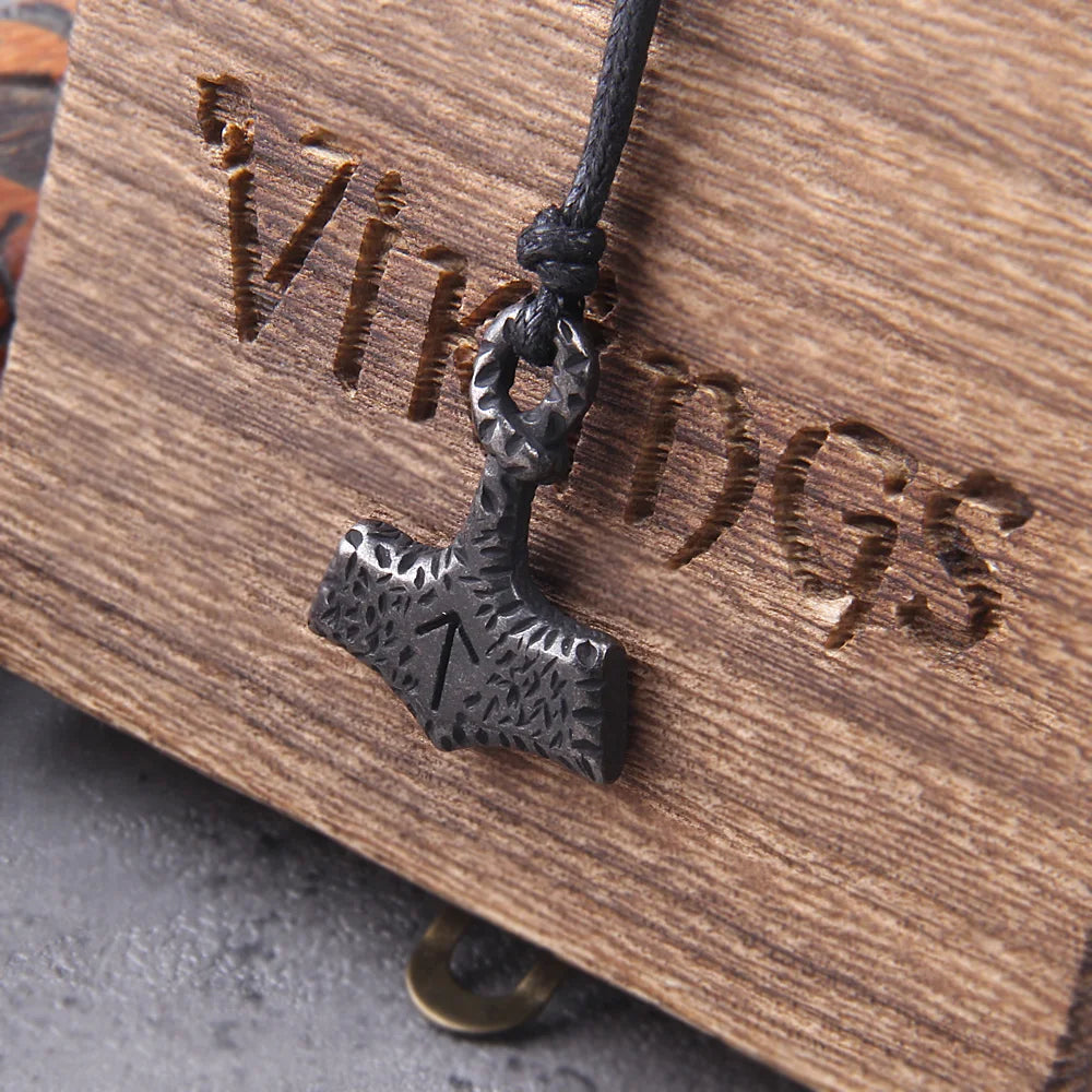 Mjölnir pendant featuring the Tiwaz rune with an aged appearance.