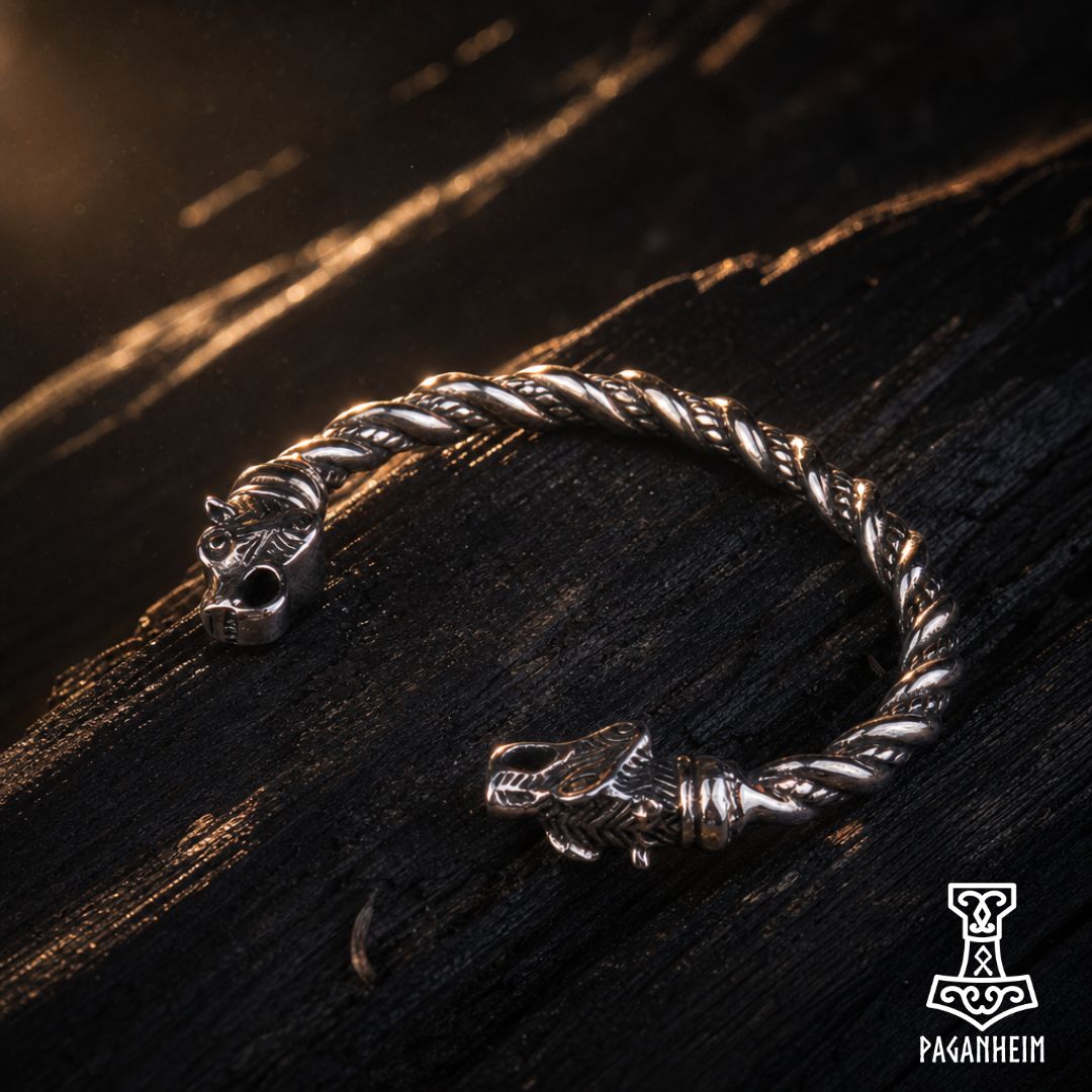 Norse bear arm ring resting on wooden surface under warm light