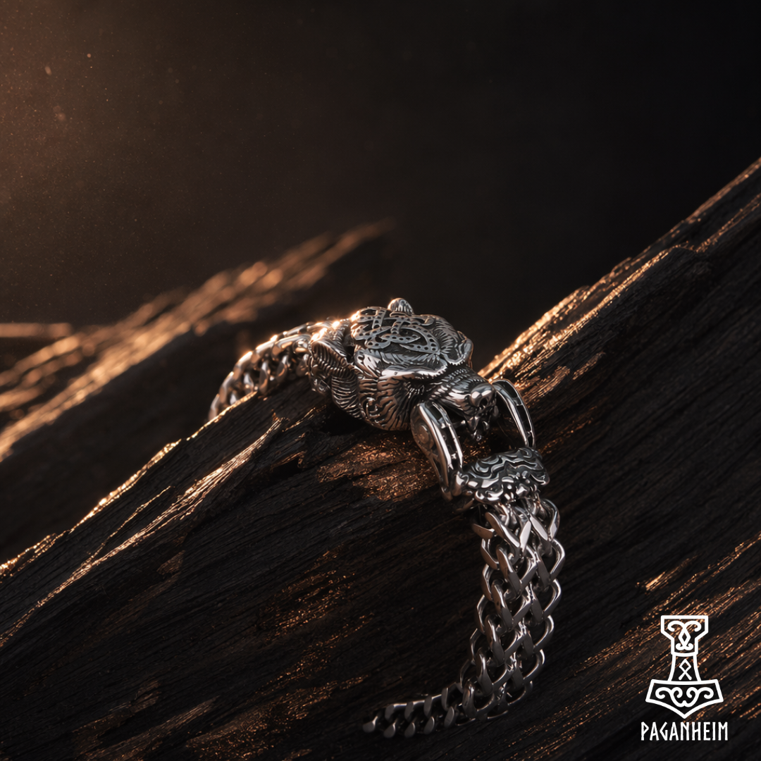 Closeup of engraved bear head forming the clasp of a metal bracelet