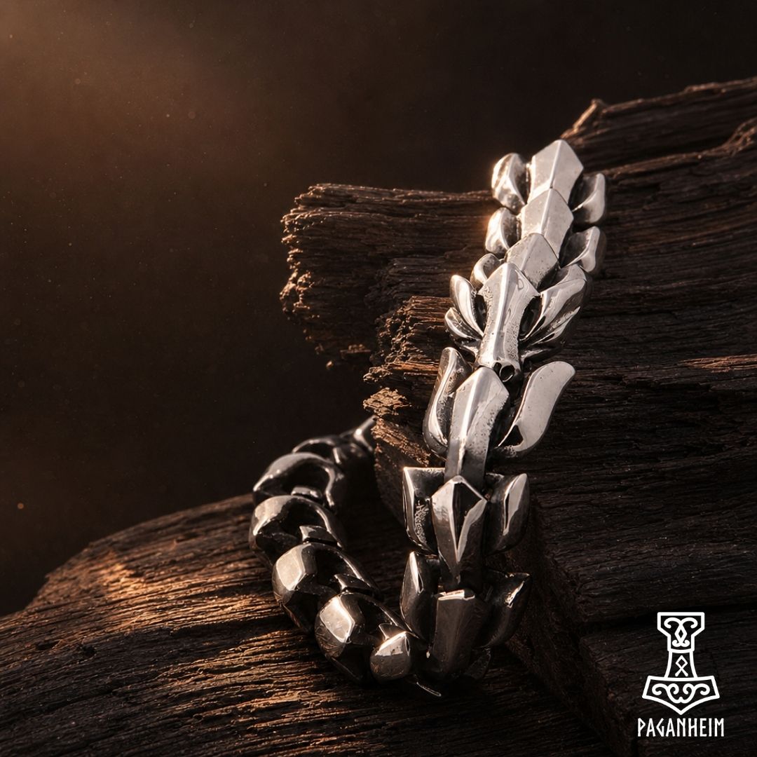 Closeup of silver serpent bracelet showing interlocking bone‑shaped links inspired by Norse mythology