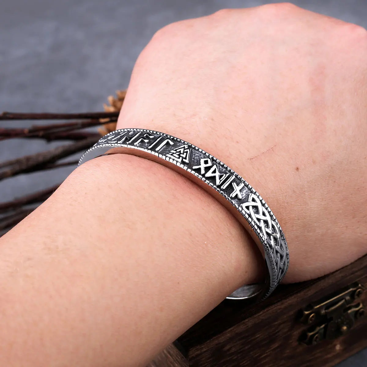 Silver-colored bangle with Norse symbols and Valknut.