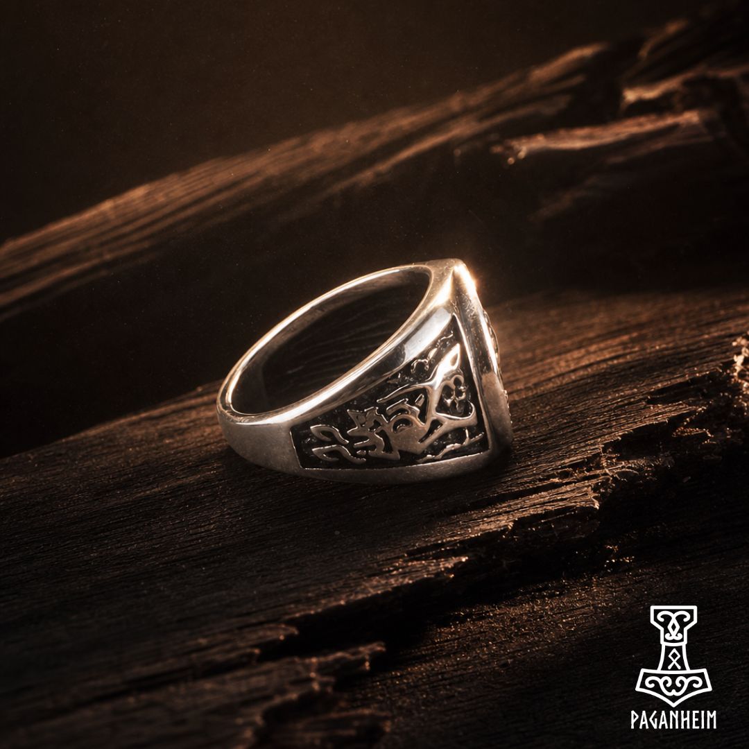 Norse Tiwaz ring resting on wooden surface under warm light