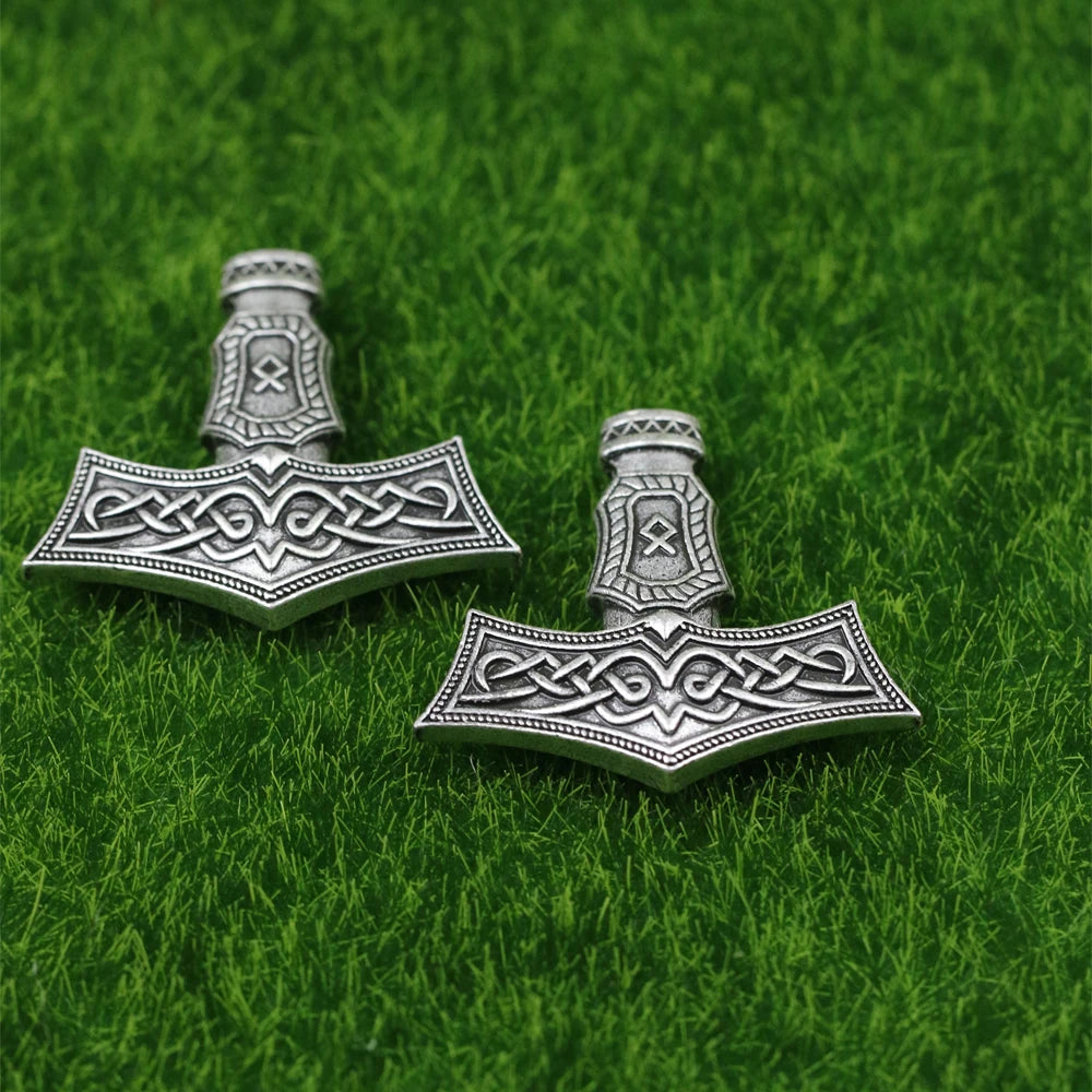 Silver-colored Thor’s hammer pendant featuring the Othala rune.