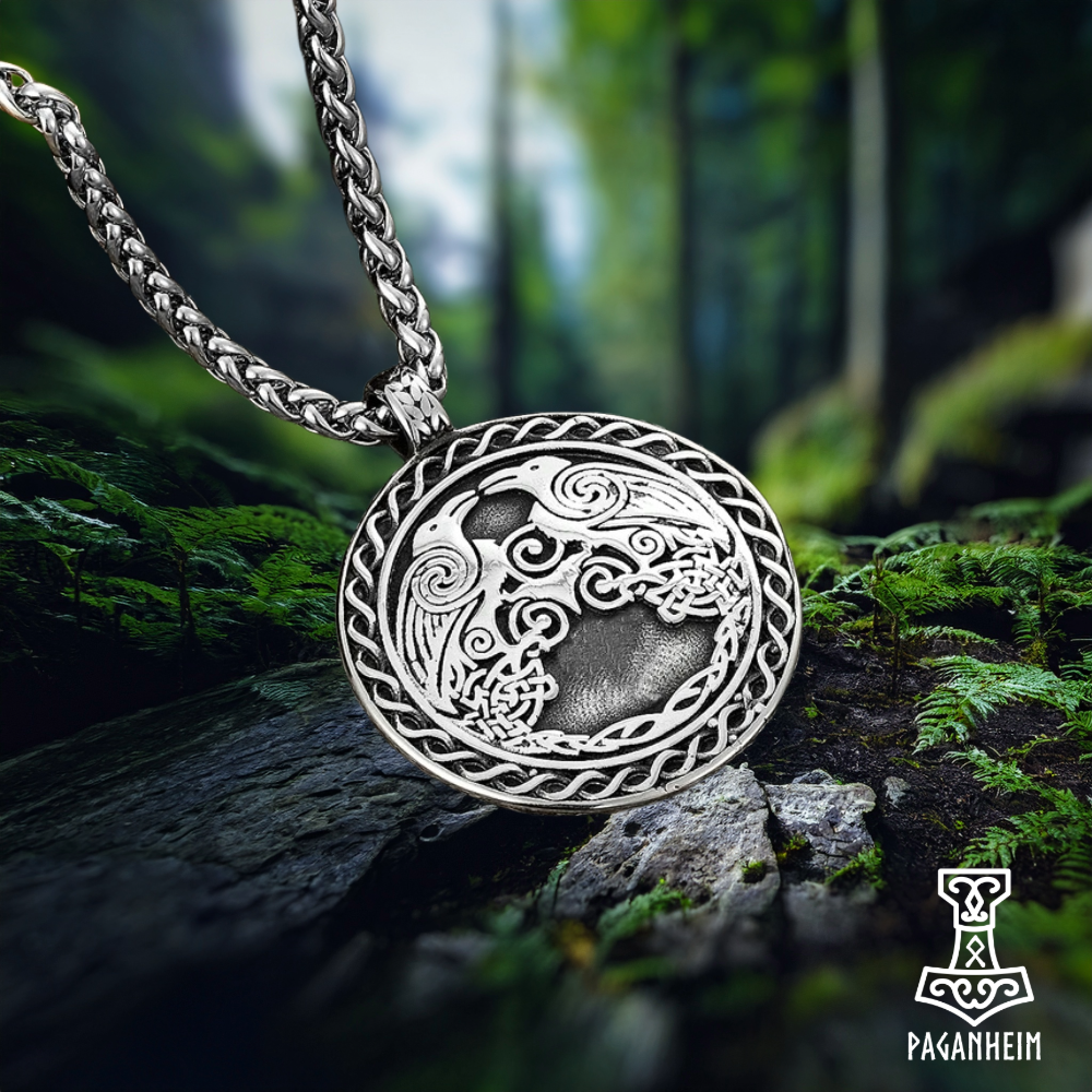 Germanic pendant showing Odin’s ravens and triskele design.