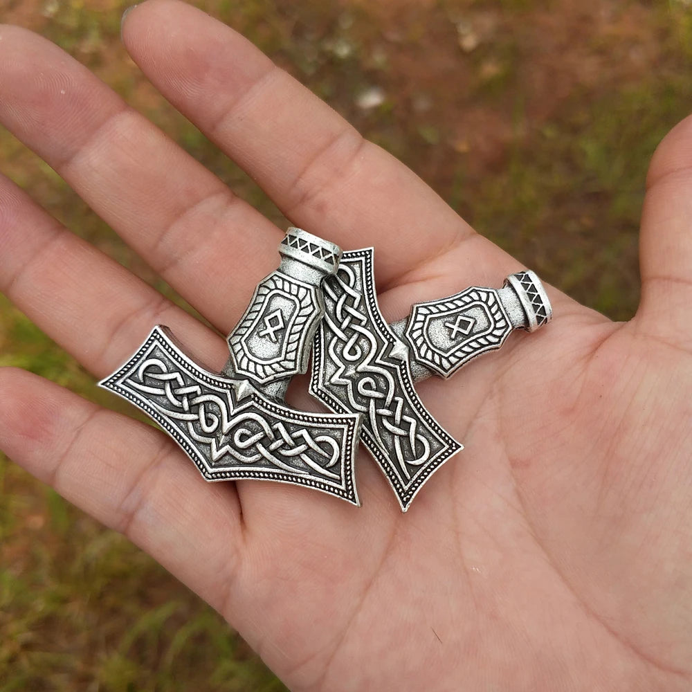 Thor’s hammer amulet engraved with the Othala rune for ancestral connection.