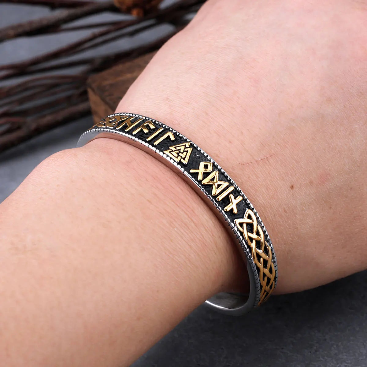 Bangle with Web of Wyrd and Valknut symbols in gold.