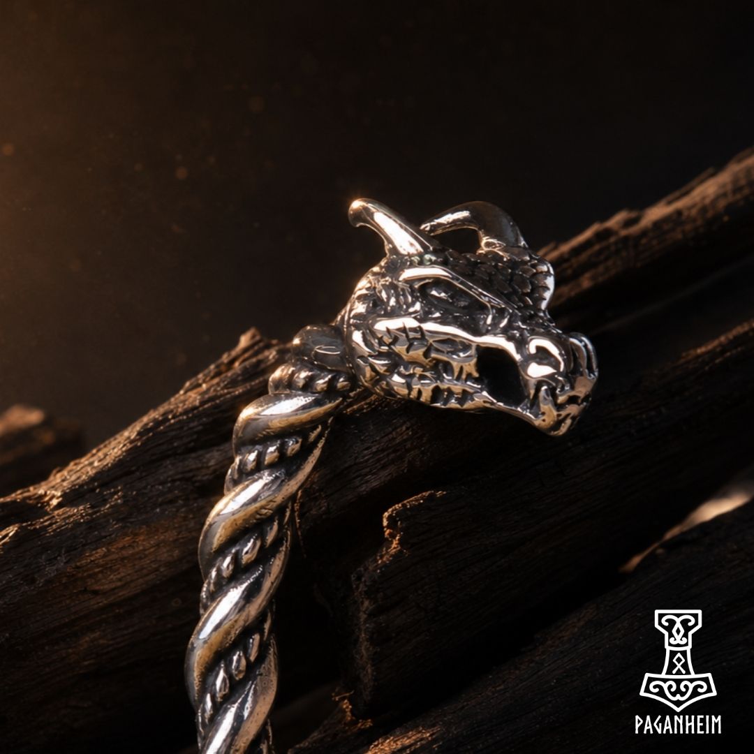 Closeup of Viking‑inspired arm ring with carved dragon motifs