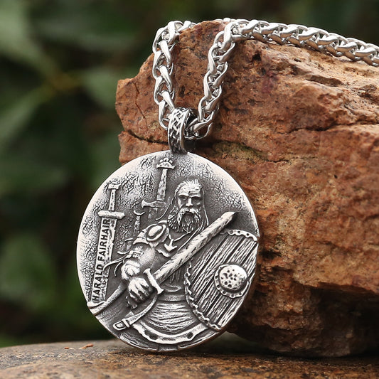 Detailed shot of the Harald Fairhair amulet, featuring side two with an engraving of the Sverd i fjell statue and Elder Futhark runes – a dual-sided masterpiece blending history, art, and Norse heritage.