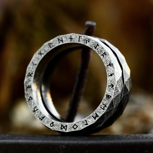 A minimalists styled viking ring, engraved with elder futhark runes with chipped hexed design on its edges