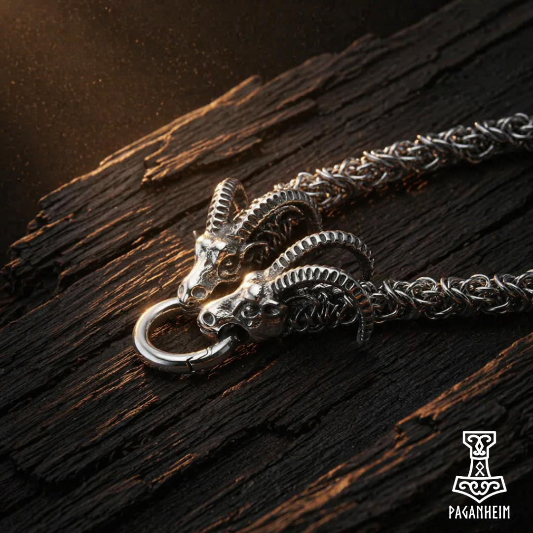 Silver ram head pendant necklace on a wooden surface with Paganheim logo.