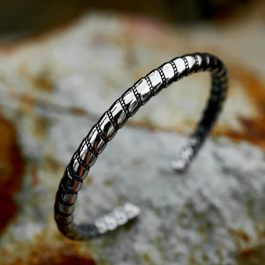 A minimalist styled viking arm ring, with a twisted design inspired by the 'Hacksilver' that were snapped off of Historical Arm Rings for trading use.