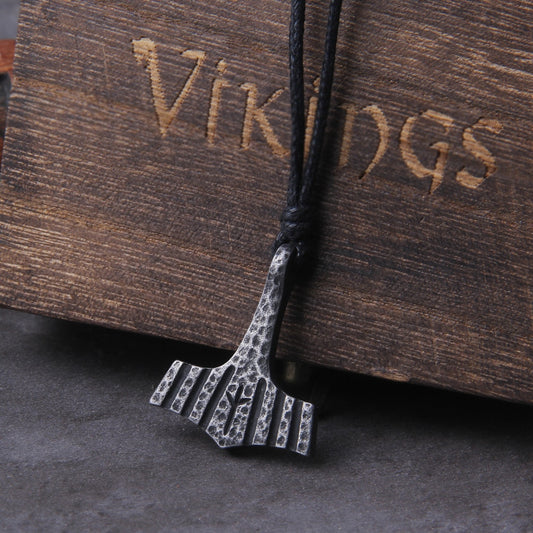 A Scandinavian Minimalistic Mjolnir Amulet, heavily inspired by real historical mjolnir amulets discovered. The Necklace Pendant has been hand chipped and engraved with the Algiz Rune, flanked on either end with a row of Engraved Grooves - Front Image