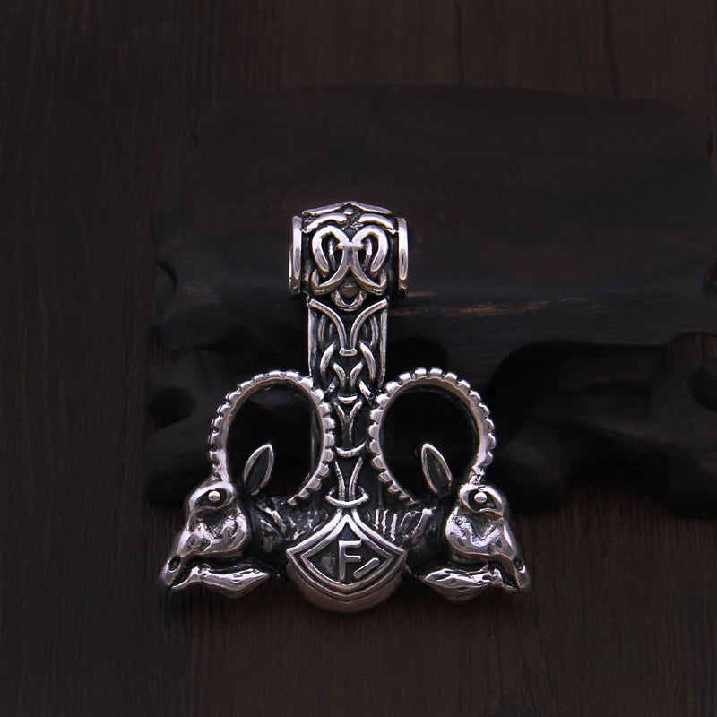 Mjölnir hammer pendant with intertwined goat heads and horns, crafted in sterling silver.