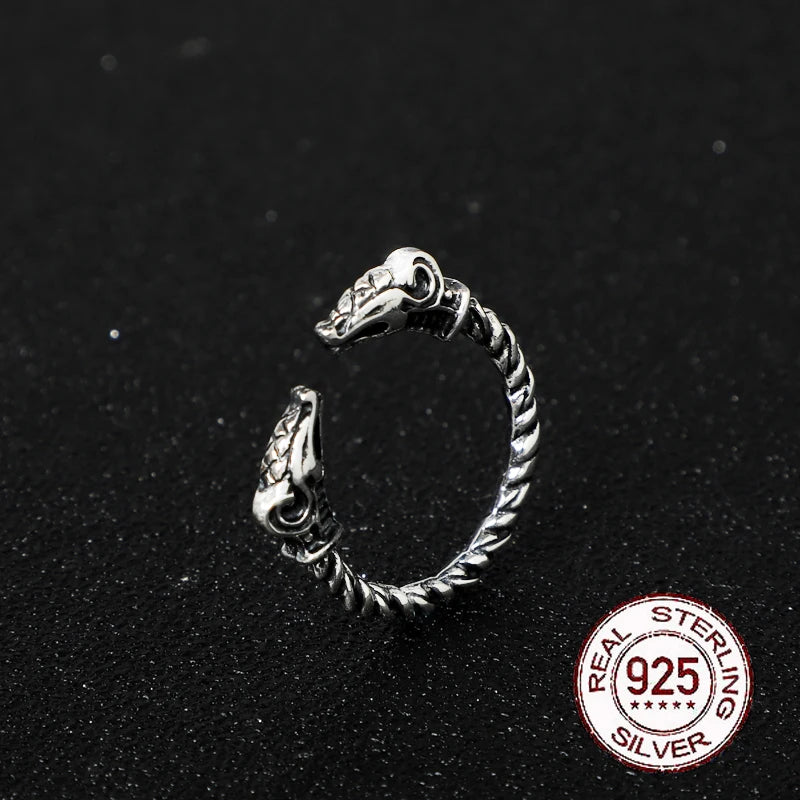 Viking-style ring with goat head ends and a twisted rod band in sterling silver.