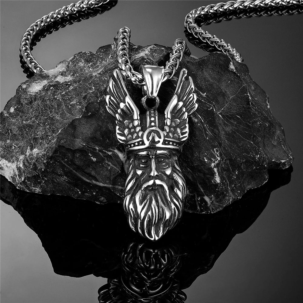 Wōden portrait amulet wearing a stylized helm that suggests wings or horns.