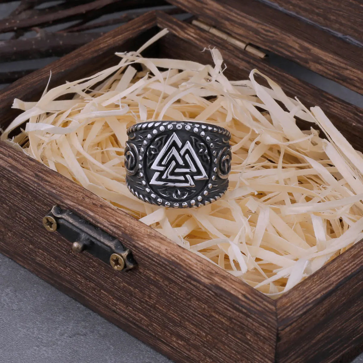 Side view of ancient Valknut ring with intricate Norse symbols