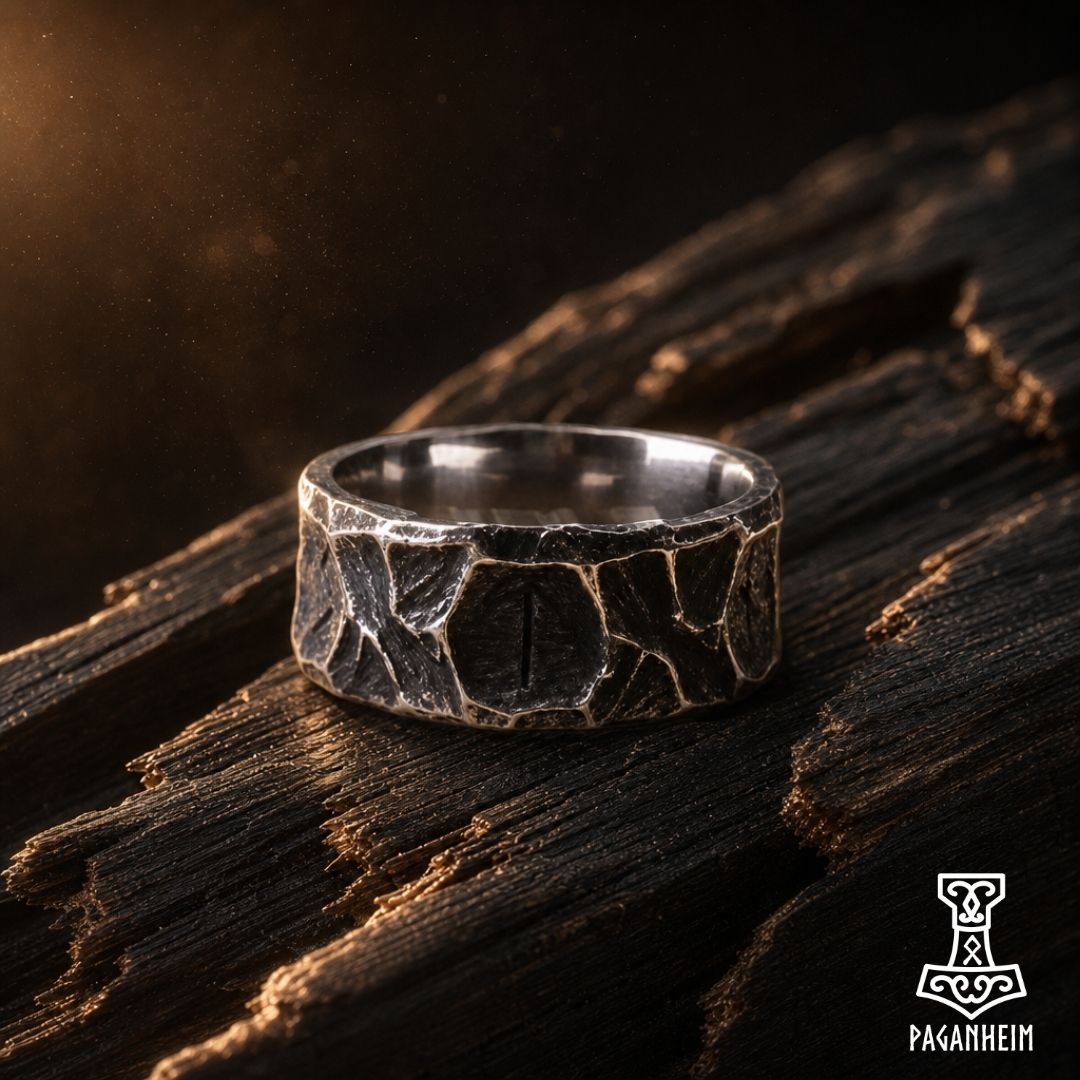 Closeup of rune ring showing engraved Futhorc symbols with rugged surface