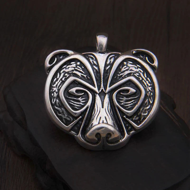 Silver amulet featuring the face of a bear, honoring Norse and Germanic traditions.