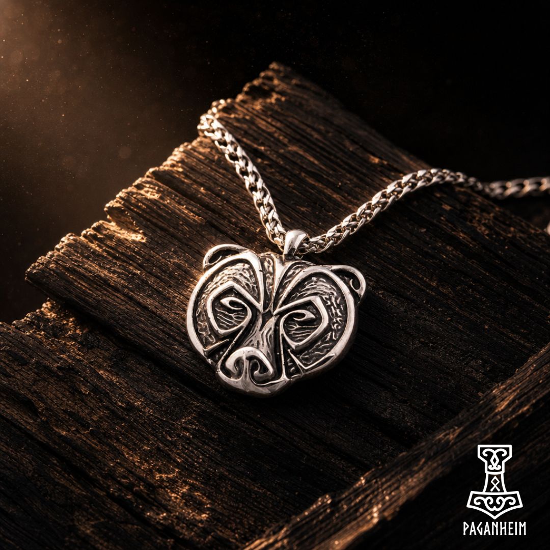 Silver pendant shaped like stylised bear head with knotwork detailing