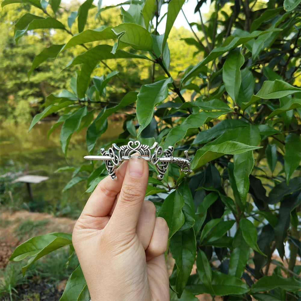 Thin hair pin brooch designed with intricate Celtic intertwining patterns.