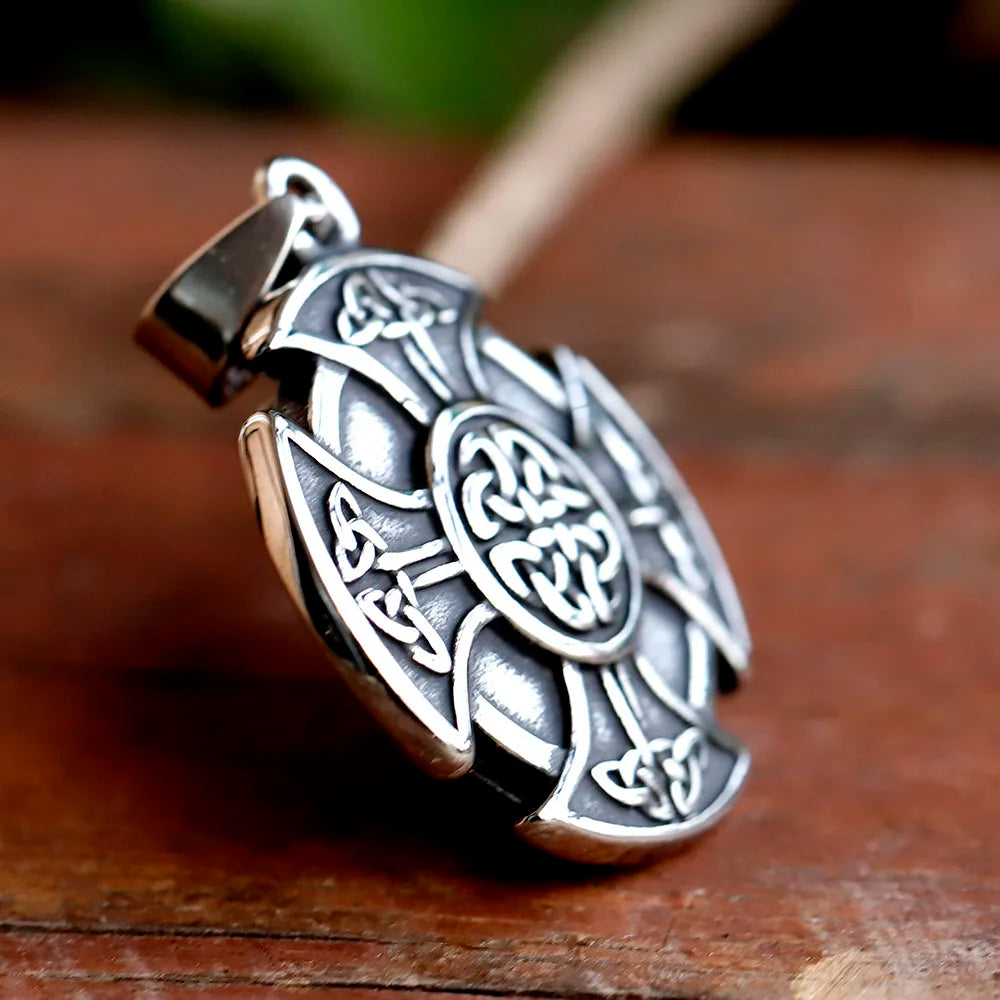 Traditional Celtic cross amulet representing life, death, and rebirth.