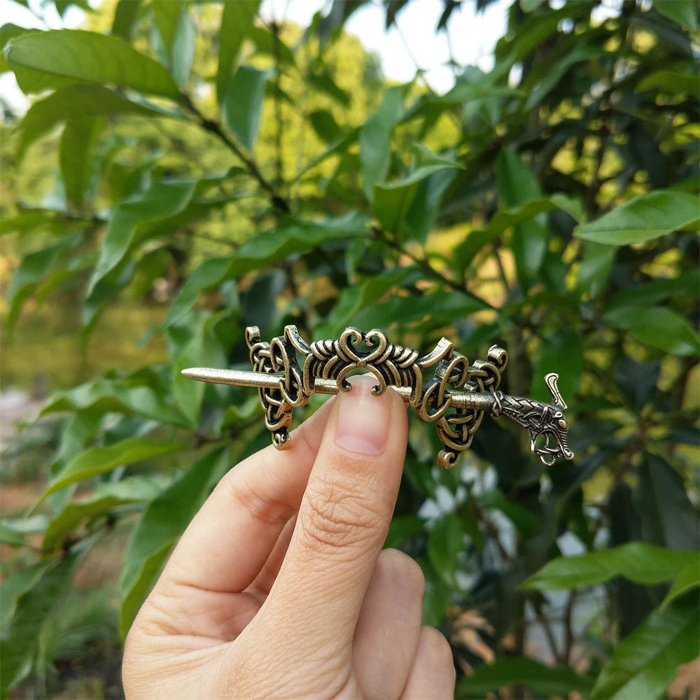 Celtic-inspired hair pin brooch with intertwined motifs.