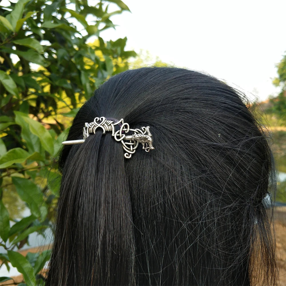 Hair pin brooch with thin design and intricate Celtic patterns.