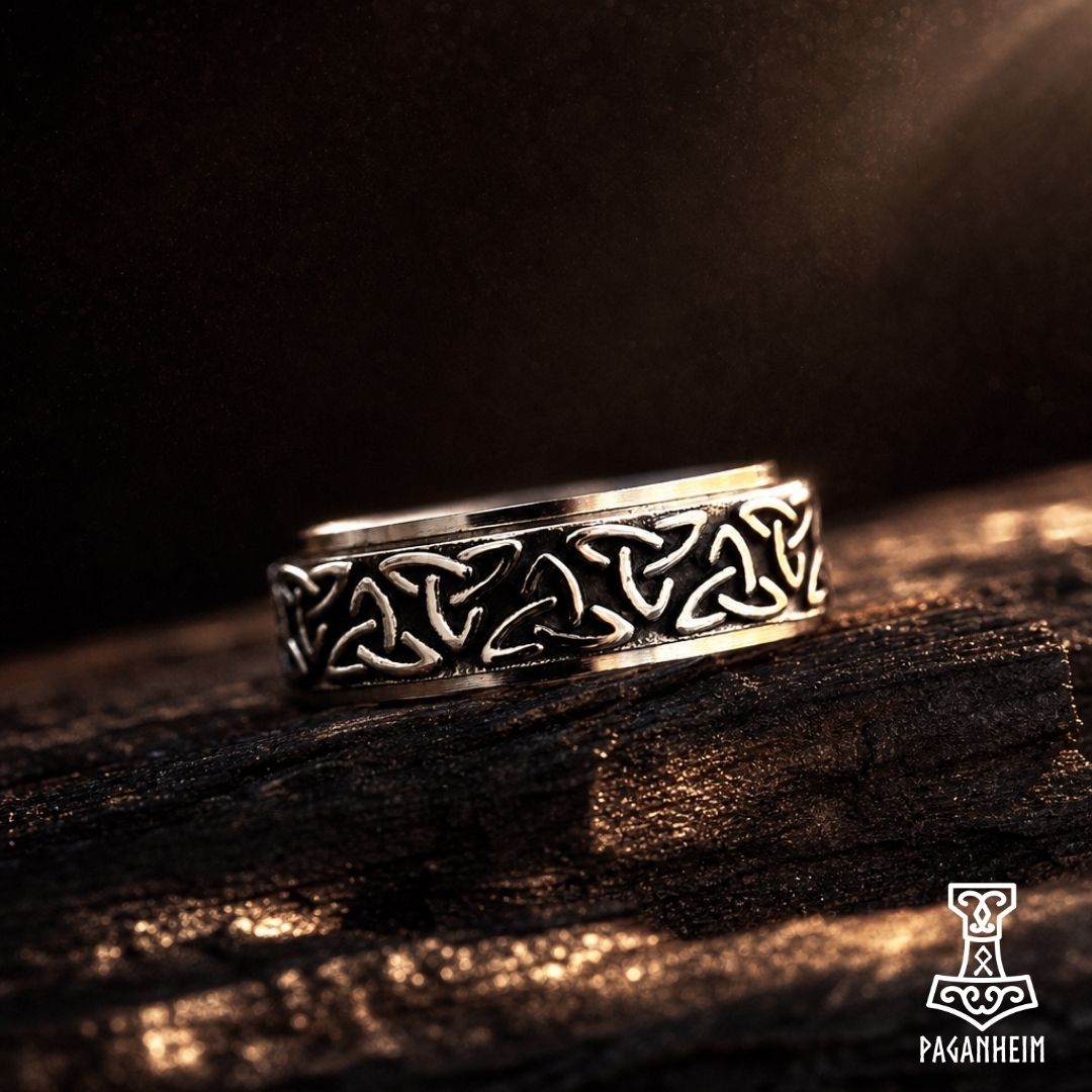 Stainless steel ring with rotating outer band engraved with Celtic triquetra symbols