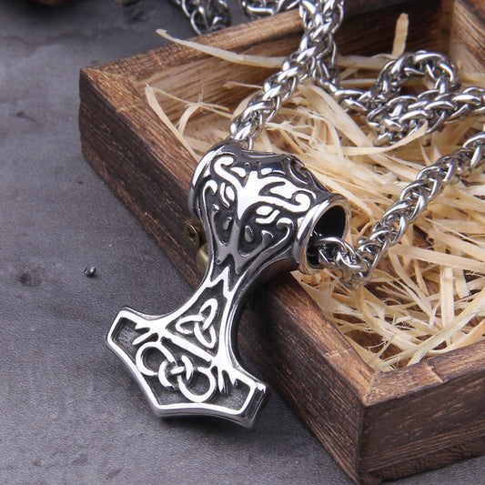 A close-up image of a Mjolnir pendant featuring intricate Celtic Knot and Triquetra symbols.
