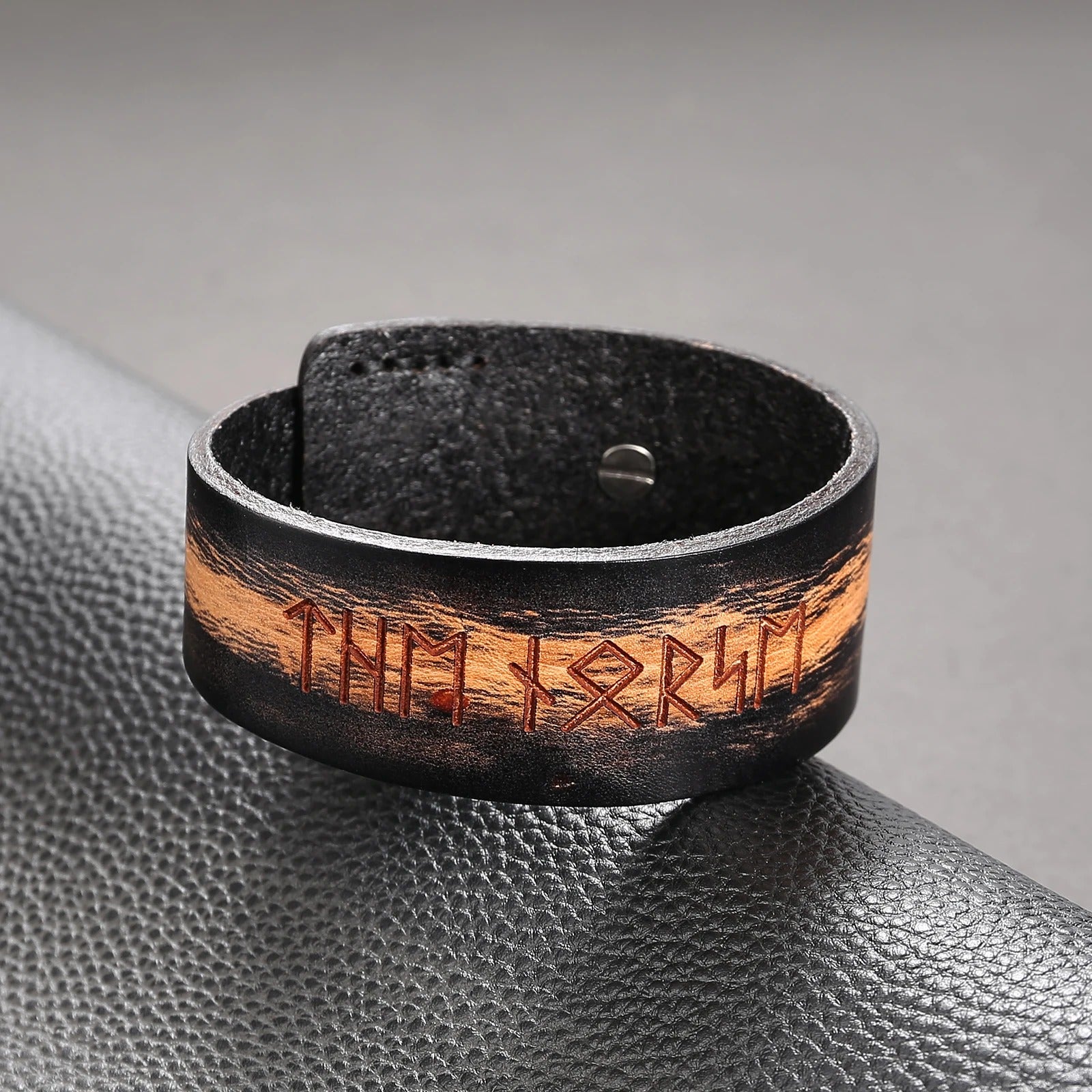 Detailed view of Elder Futhark symbols on dark leather band