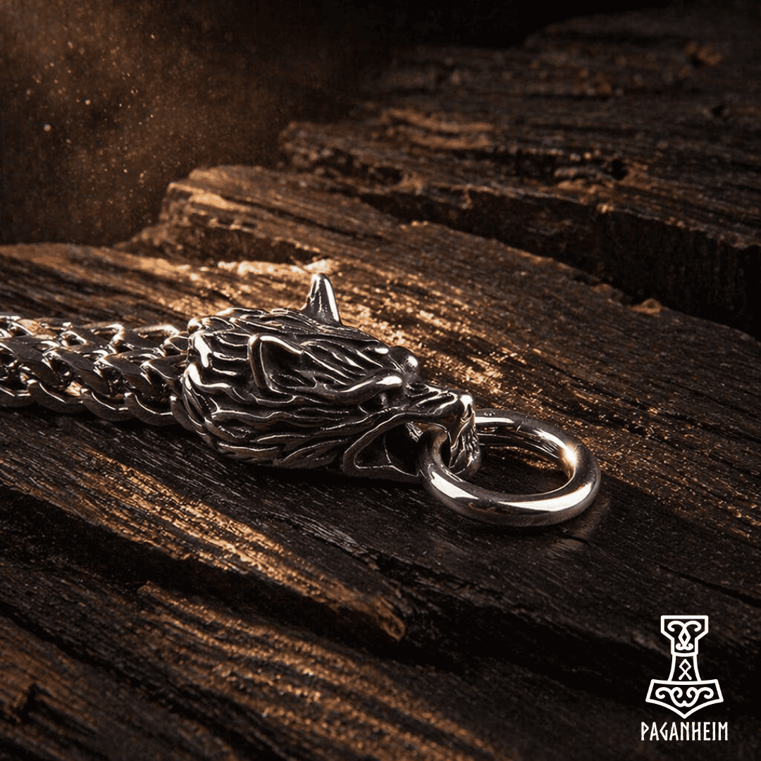Closeup of detailed wolf head clasps on metal chain bracelet