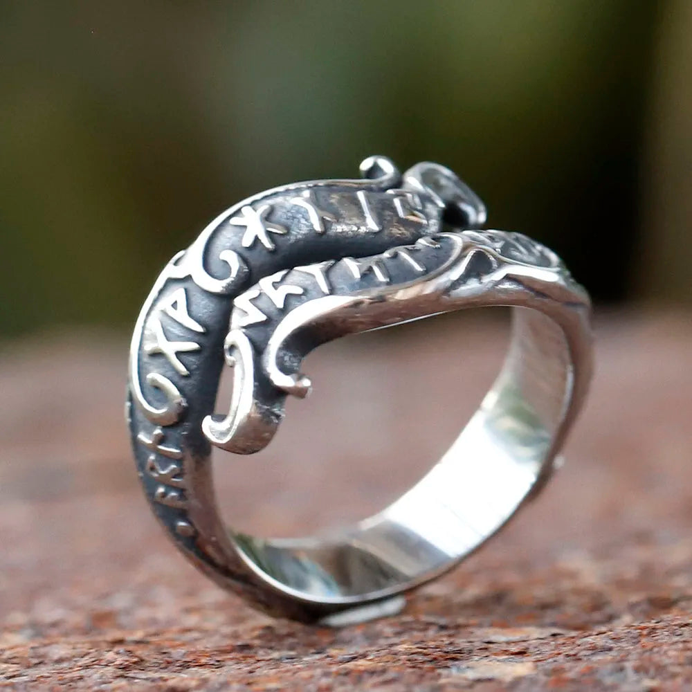 Decorative rune ring showcasing a dragon-like motif and Elder Futhark runes.