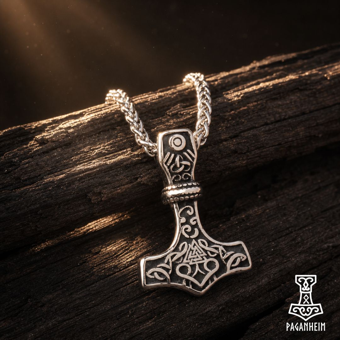 Closeup of Mjölnir pendant showing detailed knotwork and scroll patterns