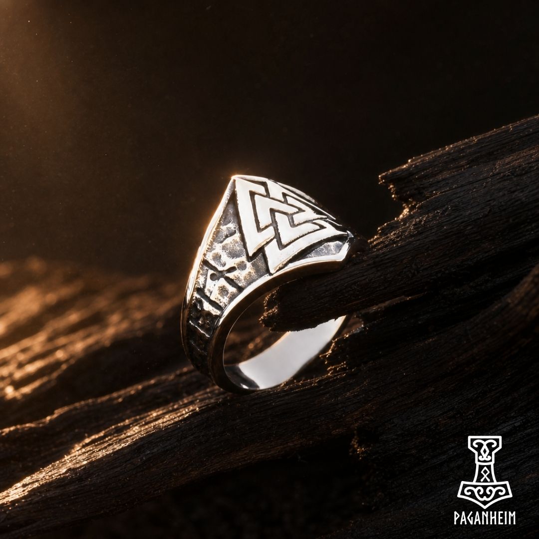 Ring featuring a raised Valknut crest with runes around the band