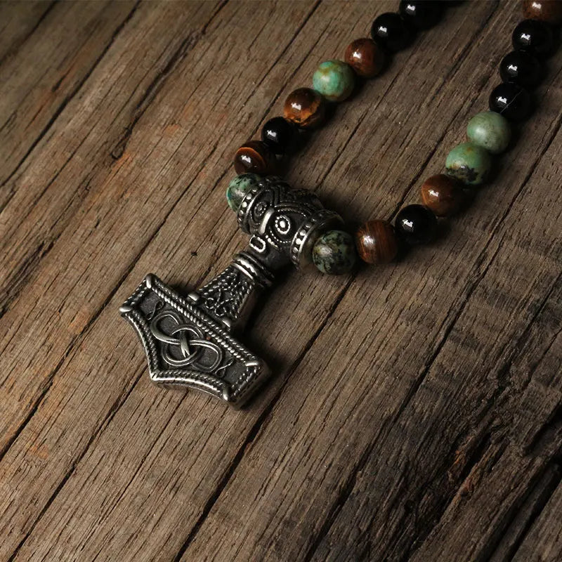 Viking amulet necklace with natural stones on the cord and choice of Mjölnir or Gungnir pendants.