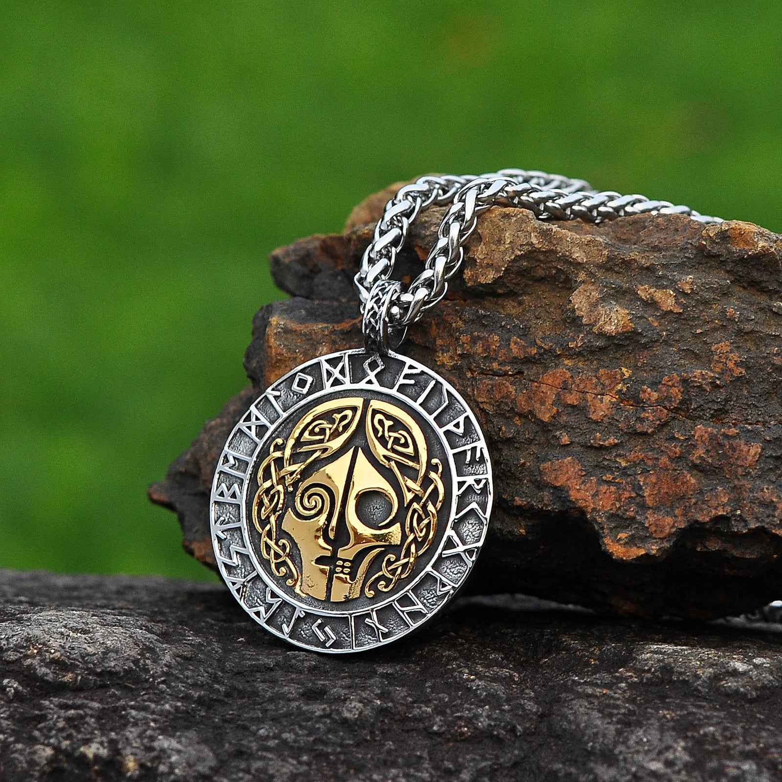 Dual-sided pendant necklace featuring Hel’s split face design on the front and the Vegvísir symbol on the reverse, framed by Elder Futhark runes.