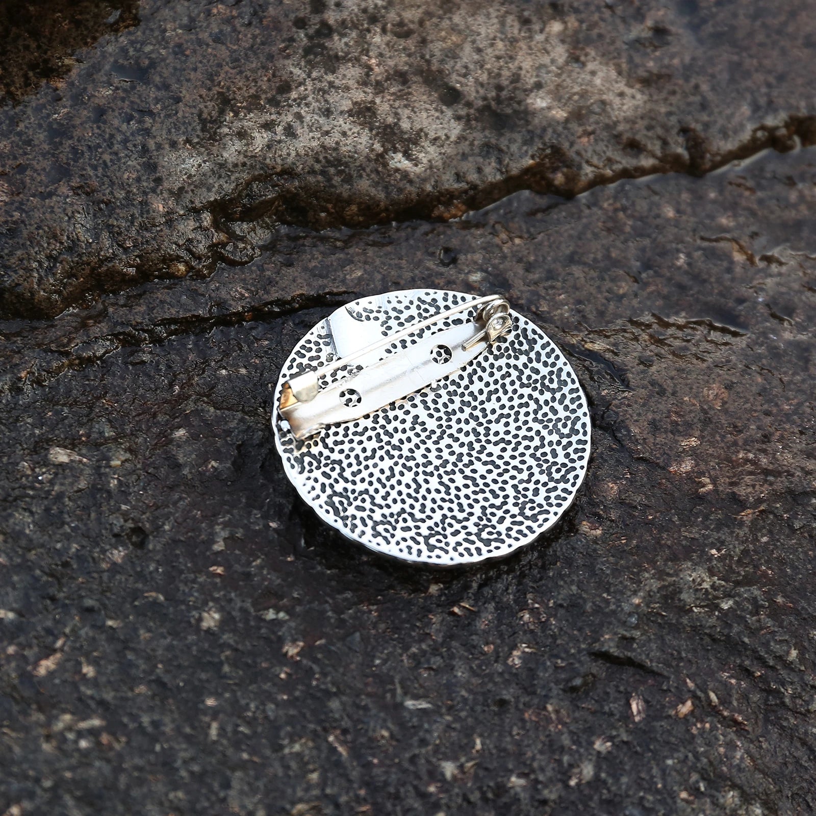 Brooch with Norse-inspired Vegvísir guidance symbol.