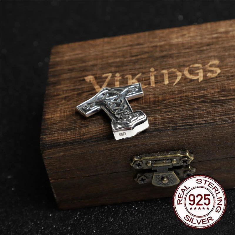 Thor’s hammer pendant featuring Jelling art and subtle raven designs, made of sterling silver.