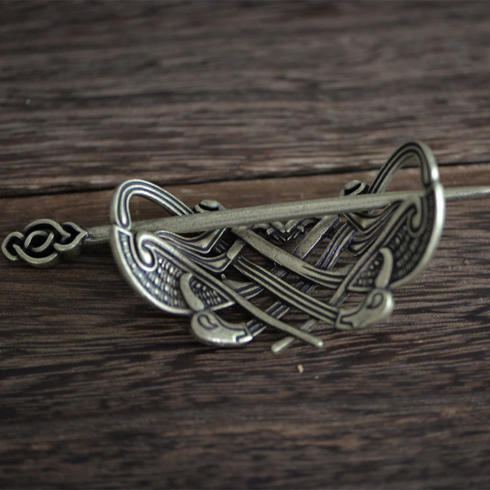 Viking-inspired hair accessory with intertwined beasts and raven designs.