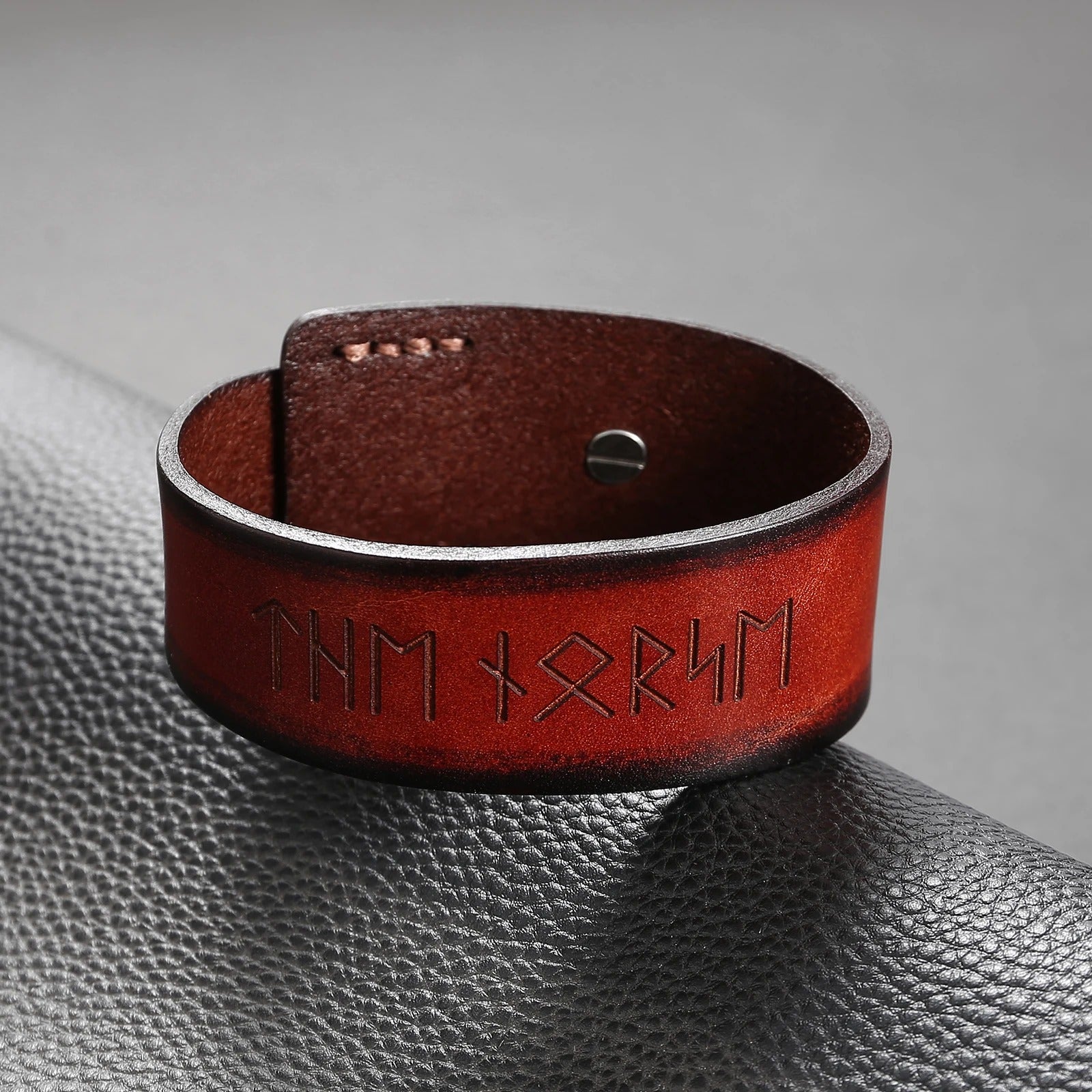 Wide leather bracelet with Elder Futhark runes etched across its surface