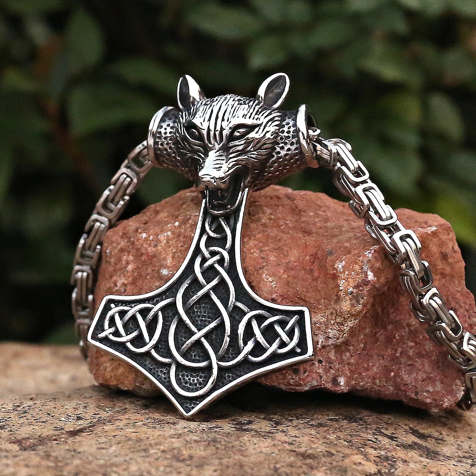 Mjölnir amulet featuring a wolf head design and intricate Celtic artistry.