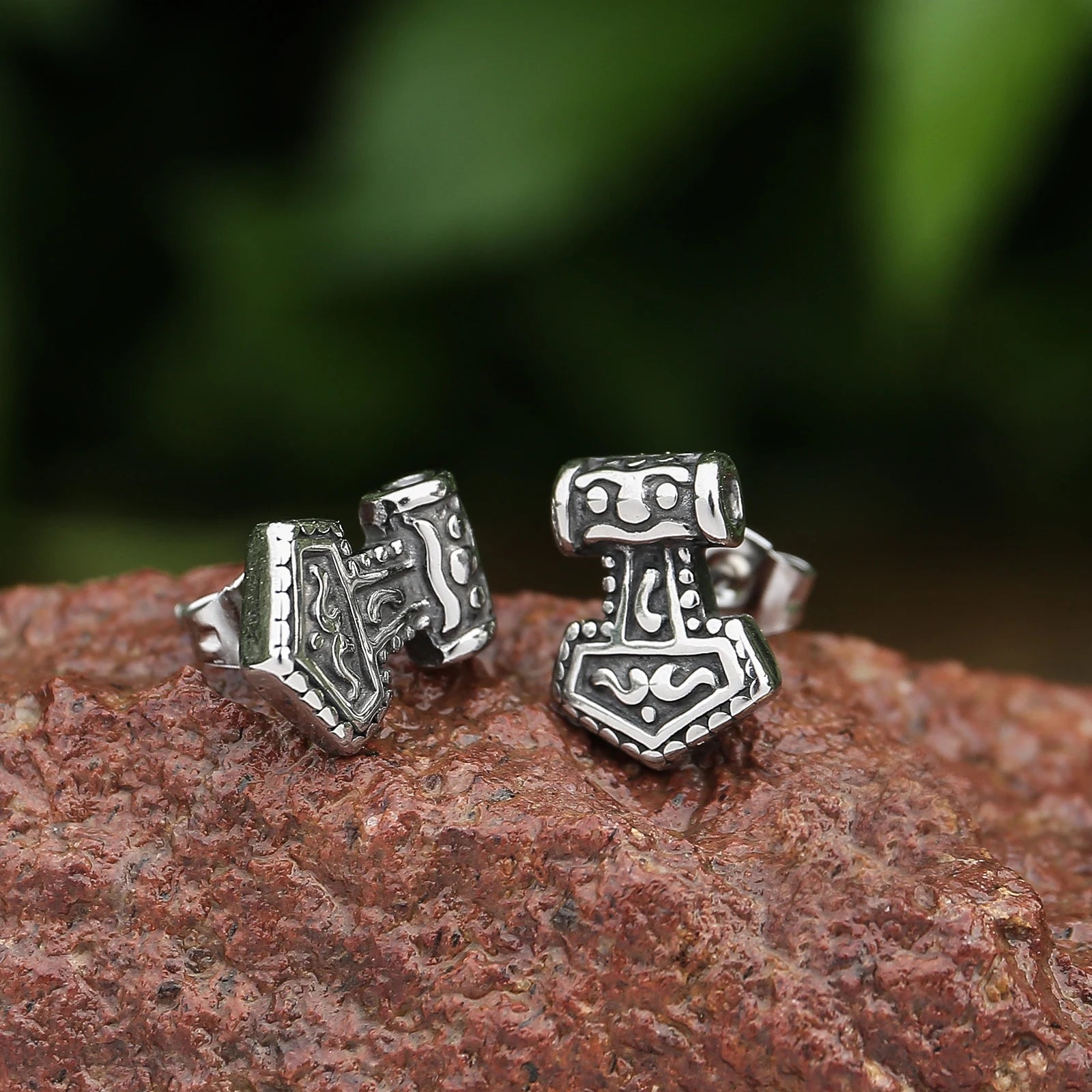 Mjölnir earrings capturing the warrior spirit of Norse mythology.