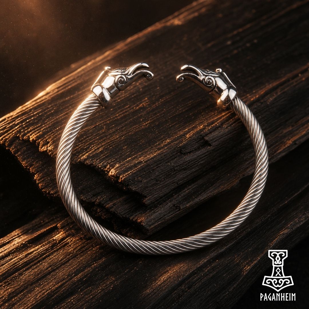 Silver arm ring featuring stylised dragon heads at each end