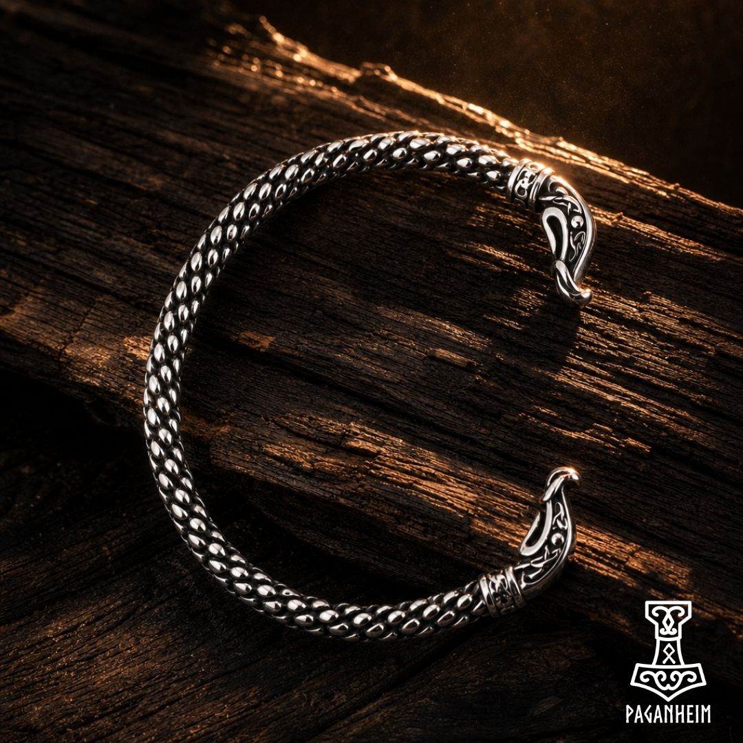 Stainless steel arm ring featuring serpent heads inspired by Viking longship prows.
