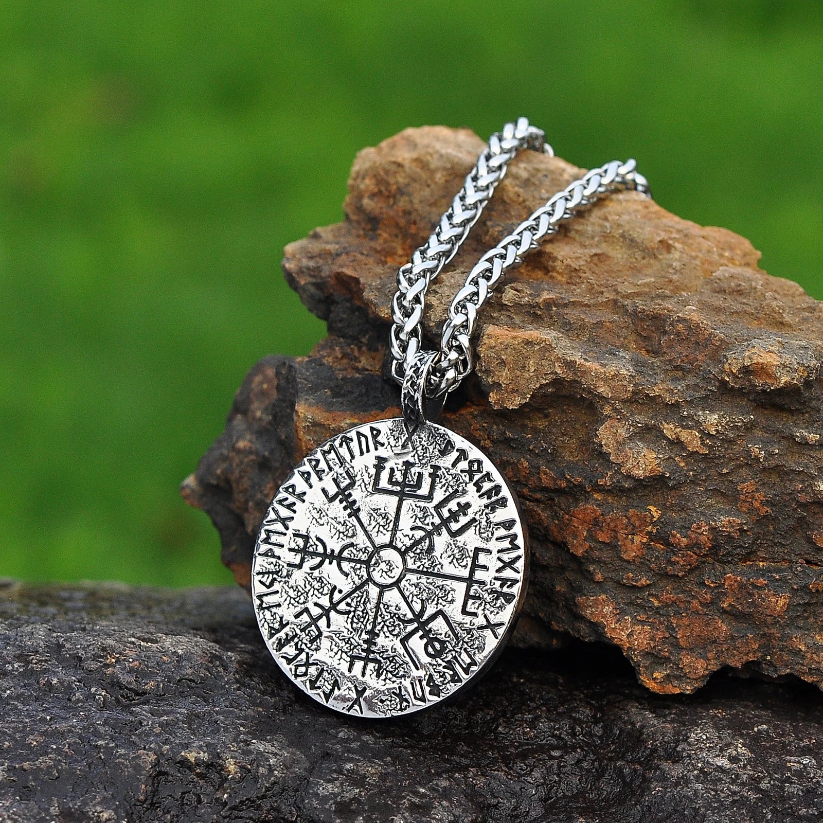 Norse Hel pendant necklace showing the goddess’s split face of life and death, with the Viking compass Vegvísir on the opposite side, surrounded by runes.