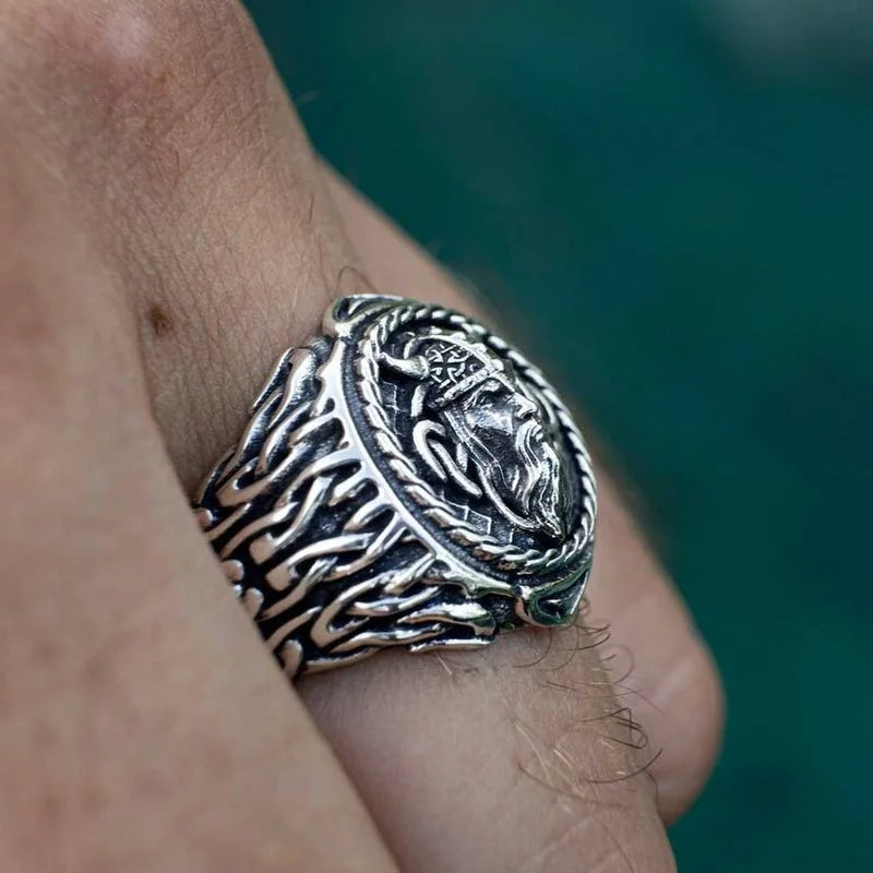 Viking warrior ring in stainless steel, showcasing detailed engravings of a warrior’s face and intricate Norse patterns.