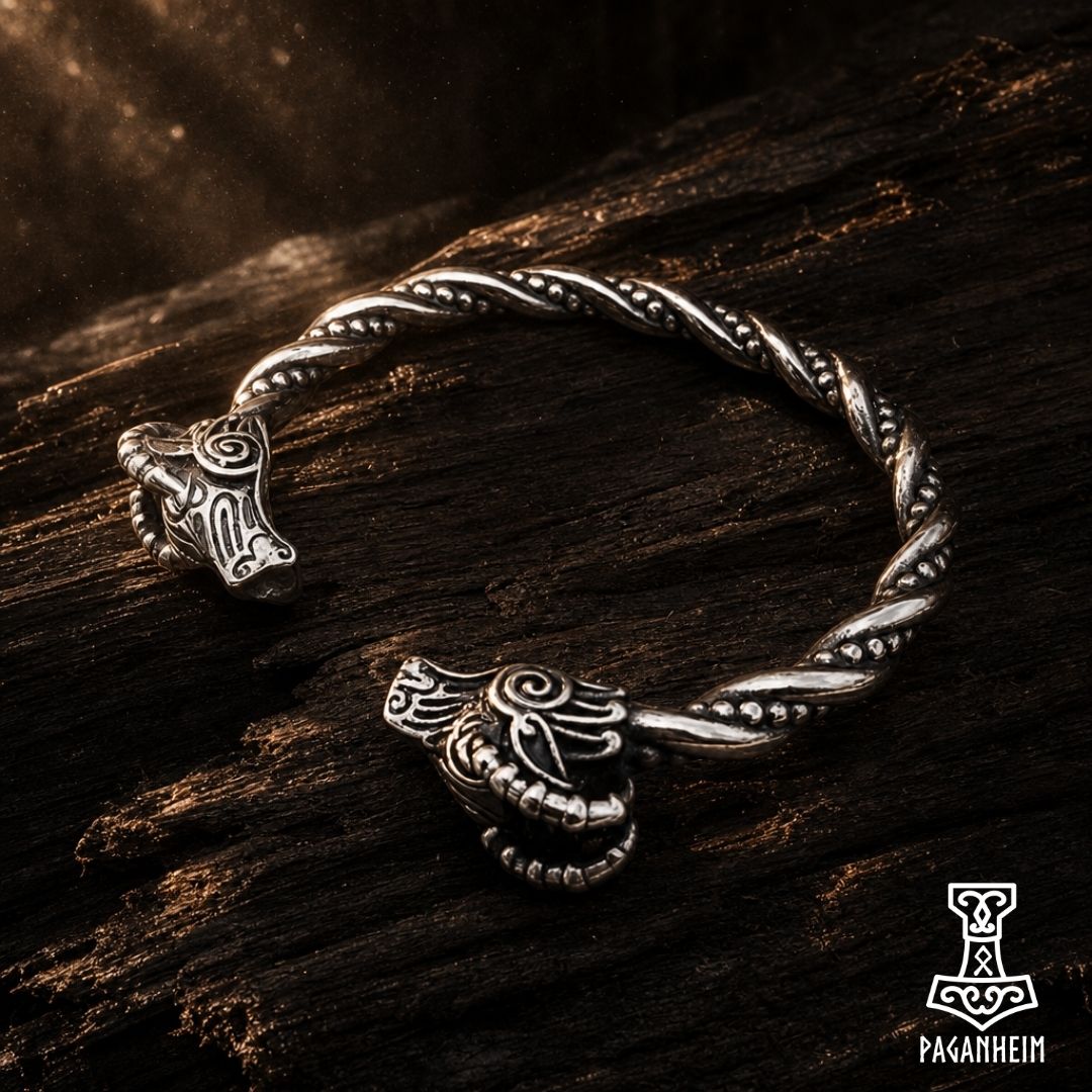 Closeup of Norse arm ring showing engraved goat heads and twisted band